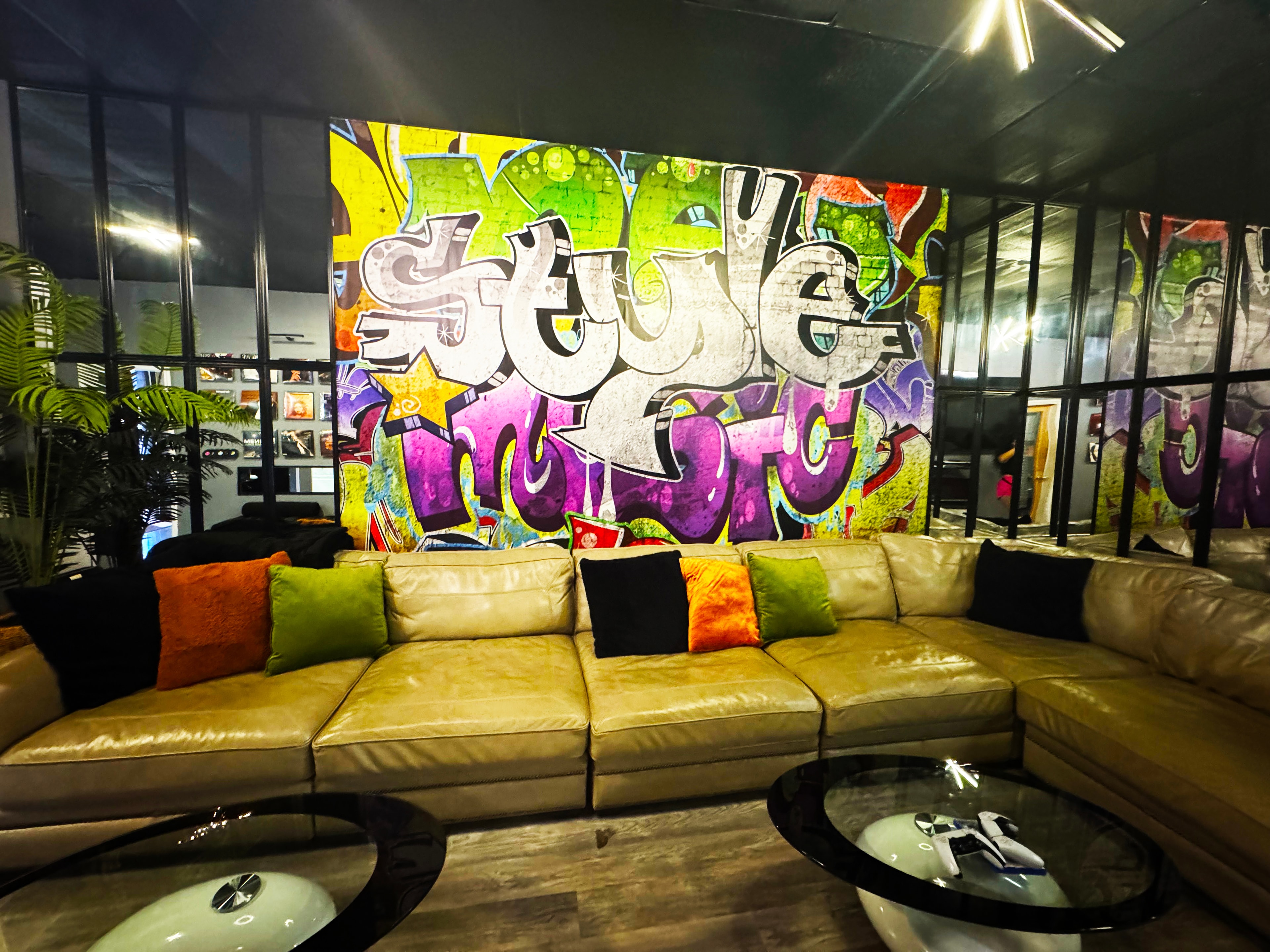 Artist lounge — premium leather sectional & graffiti feature wall