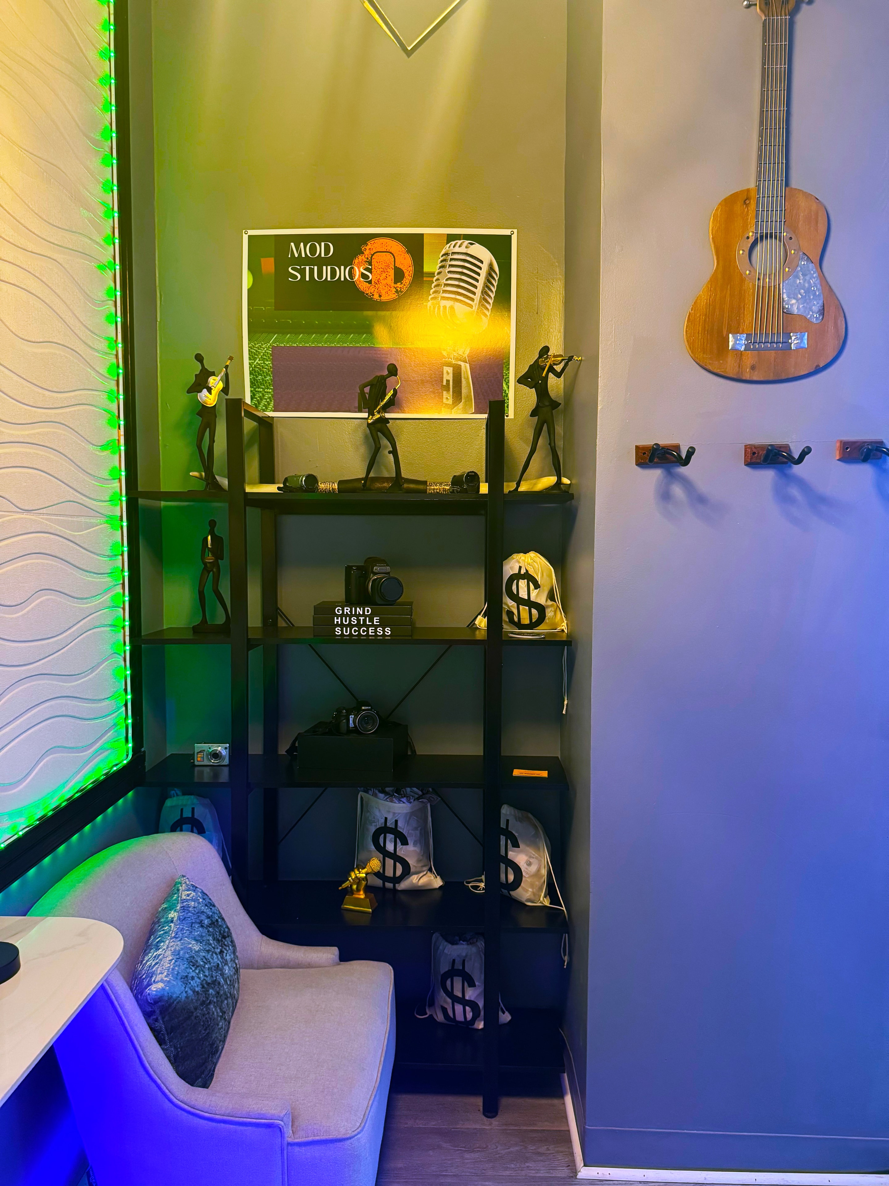 Green room — artist green room with guitar, shelving & neon ambiance